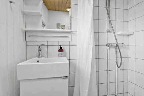 a white bathroom with a sink and a shower at 1059-Klitmoller-Mollebakken-56 in Klitmøller