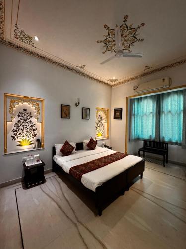 a bedroom with a large bed and a window at Hotel Boheda Palace - 1KM away from Lake Pichola in Udaipur