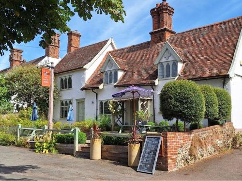 a white house with a sign in front of it at The Old Rectory Framlingham in Framlingham