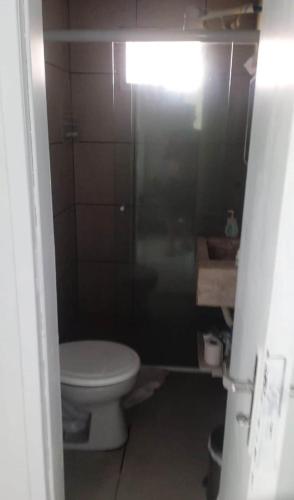a bathroom with a toilet and a glass shower at Casa em Itapucu SC a 200mts do trapiche in Araquari