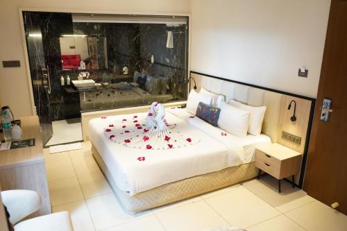 a bedroom with a large bed with flowers on it at Aarambh By The Sky Imperial Indore in Indore