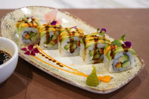a plate with sushi on top of a table at Aarambh By The Sky Imperial Indore in Indore