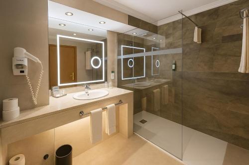 a bathroom with a sink and a shower at Hotel Baia Grande in Albufeira