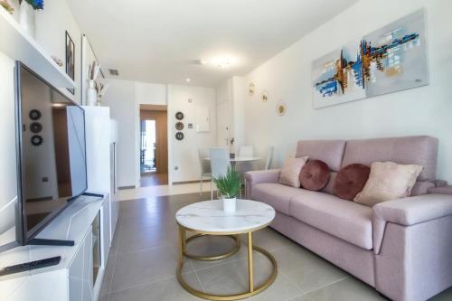 a living room with a couch and a table at Intempo by Holuxe - 034 - 3rd floor in Benidorm