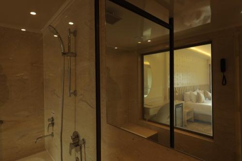 a bathroom with a shower and a mirror at Pyramids Park Resort Cairo in Cairo