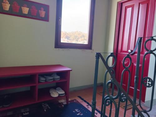 a room with a red door and a red table at Lòrien - Elegante appartamento con vista panoramica in Lucca