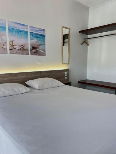 a bedroom with a large white bed with two pillows at Aldeia Da Lagoinha in Ubatuba