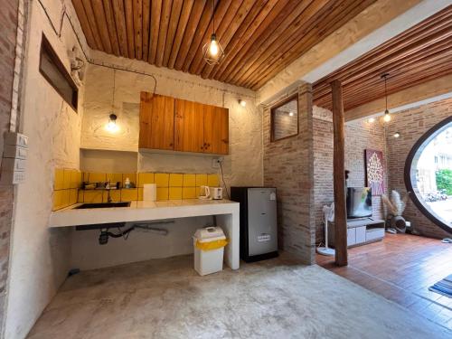 a kitchen with a sink and a refrigerator in a room at The Canopy house Private cozy stay Pai Mountains in Pai