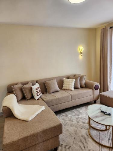 a living room with a couch and a table at Casaroca Stylish 2br in Nakuru