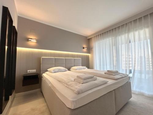 a bedroom with a large bed and a large window at Luxury Sea View - PANORAMA MAR- PUNTA PRIMA by GrupoQuattro in Punta Prima