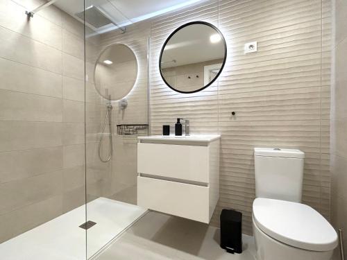 a bathroom with a toilet and a mirror at Luxury Sea View - PANORAMA MAR- PUNTA PRIMA by GrupoQuattro in Punta Prima