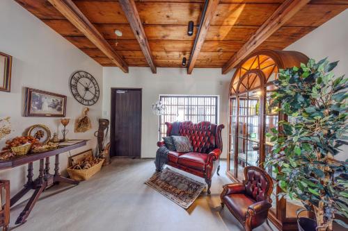 a living room with a chair and a clock at Antiques Nagoya Station East -アンティークス名古屋駅東- in Nagoya