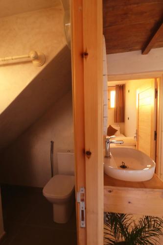 a bathroom with a sink and a toilet and a staircase at hyle Surfhouse in Agadir
