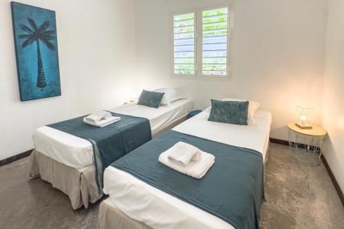 En eller flere senge i et værelse på Villa Ixora - Piscine Privée