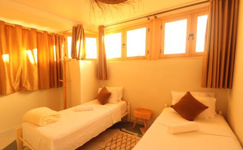 Postel nebo postele na pokoji v ubytování hyle Surfhouse