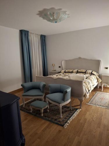 a bedroom with a bed and a couch and chairs at Il Borgo By Phoenix in Olmo al Brembo
