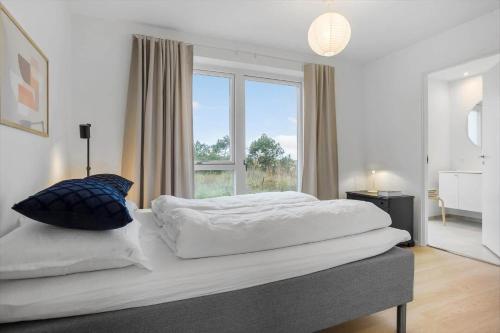 une chambre avec deux lits et une grande fenêtre dans l'établissement 1305-Snedsted-Klitfogedvej-5, à Snedsted