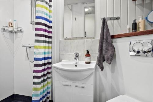 a white bathroom with a sink and a shower curtain at 254-Vestervig-Havnevej-1-lejl-4 in Vestervig