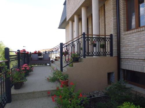 a balcony with potted plants on a house at Villa Homestay Nad Helmrovkou in Prague