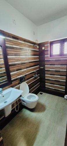 a bathroom with a toilet and a sink at 1 navarethna Villa in Trivandrum