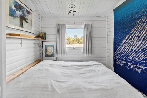 a small bedroom with a bed in a room with a window at 309-Bedsted-Thy-Redningsvej-9 in Bedsted Thy
