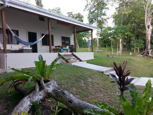 a house with a tree trunk in front of it at Aoredise in Luganville