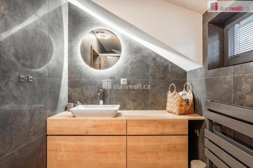 a bathroom with a sink and a mirror at Apartmány Fun & Relax Dolní Morava in Dolní Morava