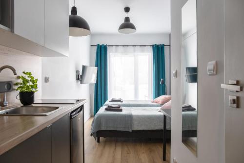 a kitchen with a bed and a sink in a room at ADLER Studio in Łódź