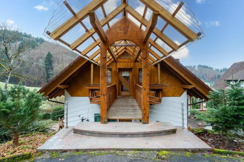 a wooden house with a glass roof and stairs at Haus Sigmund in Waldhäuser