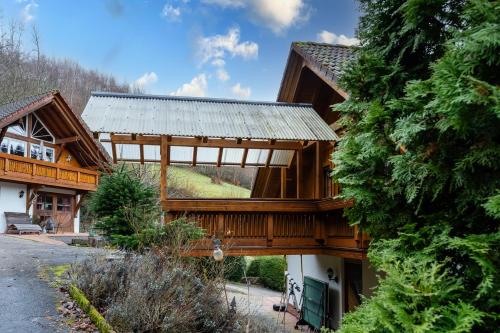 a log home with a metal roof at Haus Sigmund in Waldhäuser