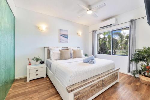 a bedroom with a large bed and a window at Style, Luxury and Comfort in Larrakeyah in Larrakeyah