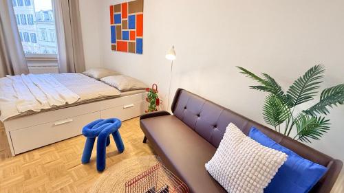 a bedroom with a bed and a couch in it at M8 ParkSide Studio One in Graz