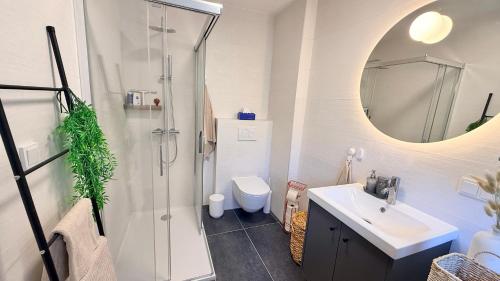 a bathroom with a shower and a sink and a toilet at M8 ParkSide Studio One in Graz