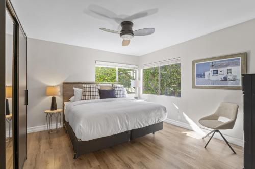 a white bedroom with a bed and a window at Hideaway ALL Walk to the Beach Downtown AC in San Clemente