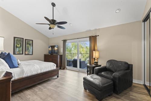 a bedroom with a bed and a chair and a ceiling fan at Bright 3BR Beach Condo Near Casino and Ole Hanson in San Clemente