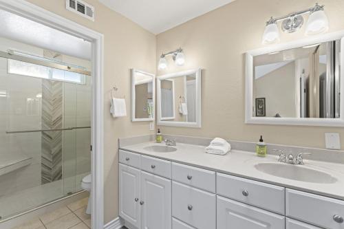 a bathroom with two sinks and a shower at Bright 3BR Beach Condo Near Casino and Ole Hanson in San Clemente