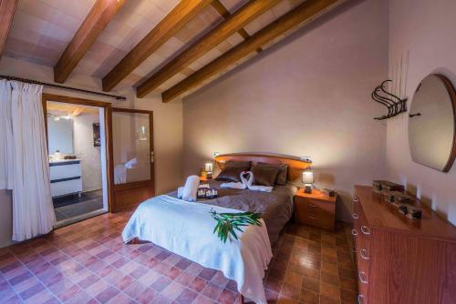 a bedroom with a bed and a sink and a mirror at Ca na Vilaneta in Caimari