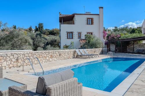 a villa with a swimming pool and a house at Vamos villa in Vamos