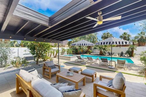 an outdoor patio with white furniture and a pool at Jewel of the Desert 259-342 in La Quinta