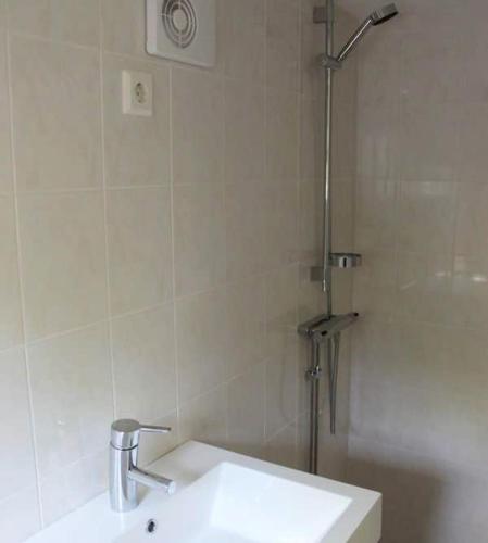 a bathroom with a sink and a shower at Two cottages by the forest & sea SE09136 in Henån
