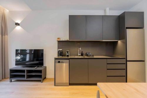 a kitchen with stainless steel appliances in a room at Stancia Benimaclet - Studio 9 in Valencia