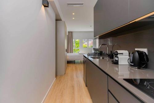 a kitchen with a counter top with a sink and a counter top at Stancia Benimaclet - Studio 7 in Valencia