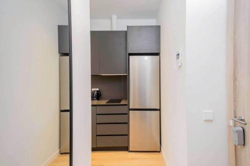 a kitchen with stainless steel appliances in a room at Stancia Benimaclet - Studio 7 in Valencia