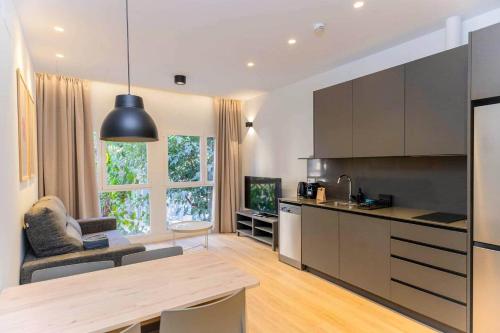 a kitchen with a table and a dining room at Stancia Benimaclet - Studio 1 in Valencia