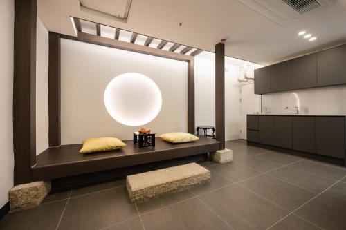 a room with two pillows on a bench with a large orb at 율 한옥 호텔 in Samgong