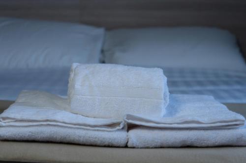 a pile of towels sitting on top of a bed at McCloskeys Residences in Dublin