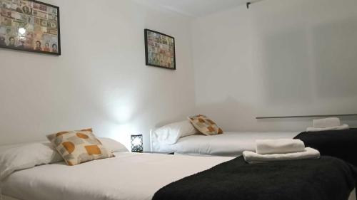 Ένα ή περισσότερα κρεβάτια σε δωμάτιο στο Encalma Vacacional siente disfruta vive la playa