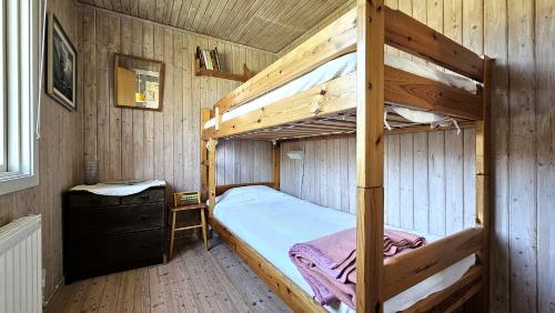 a bedroom with two bunk beds in a cabin at Cozy cottage near Hälleviksstrand SE09132 in Hälleviksstrand