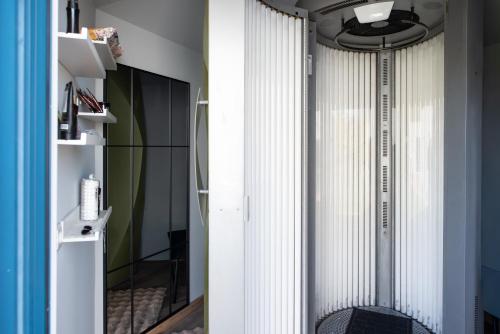 a room with a vertical radiator and a mirror at Moonloungeresort in Kalviai