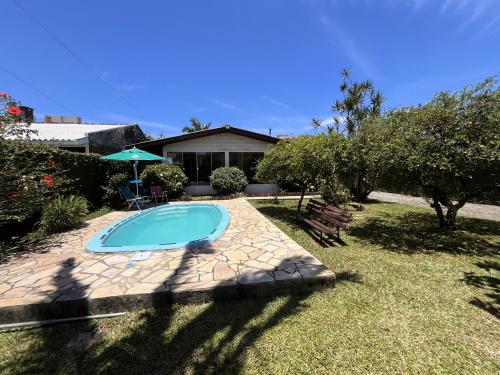 a swimming pool in the yard of a house at Pepa Kingdom in Matinhos